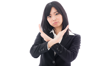 attractive asian businesswoman showing x sign